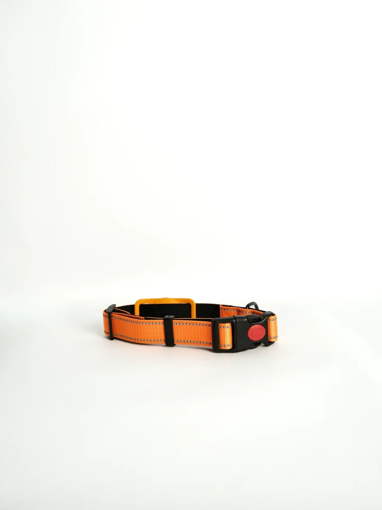 Peach Apple AirTag Dog Collar shown at a side angle, highlighting the secure integrated tracking holder.