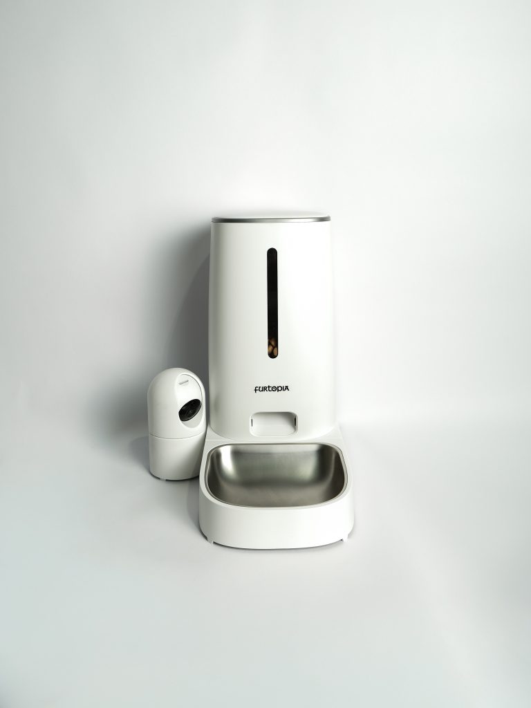 White Furtopia Automatic Pet Feeder with Camera showing the sleek modern design and food dispensing tray.