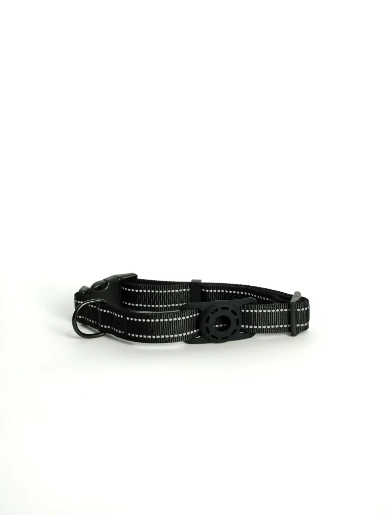 Detailed shot of the secure AirTag pocket on the black adjustable pet collar, designed for stress-free tracking.
