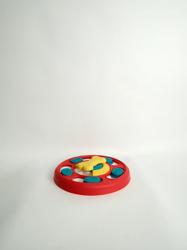 Top view of the interactive Dog Puzzle Feeder Toy featuring colorful sliding panels and hidden treat compartments.