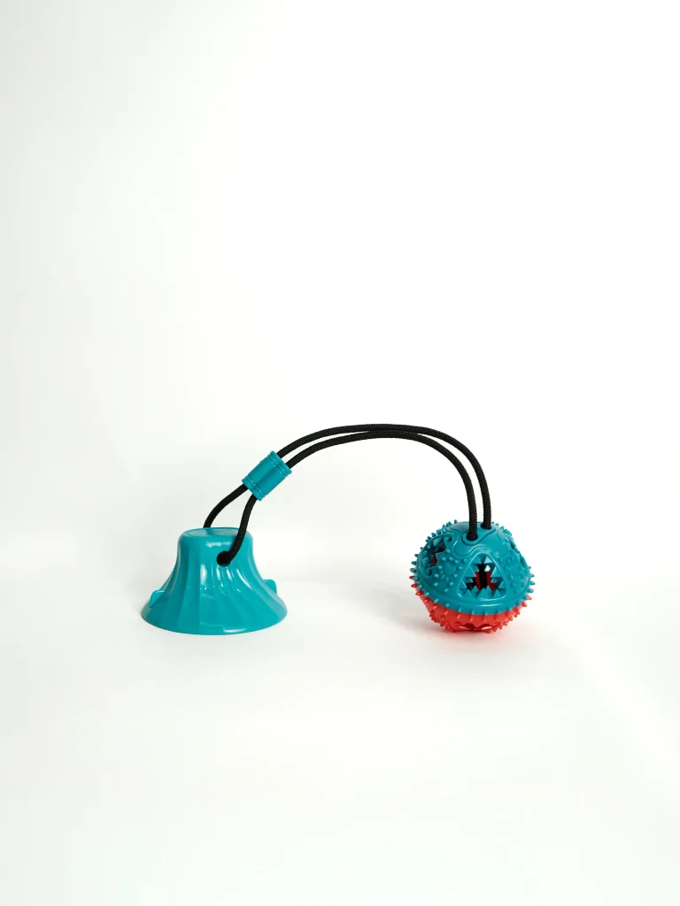 Side view of the treat dispenser opening on the heavy-duty rubber Dog Chew and Feeder Toy.